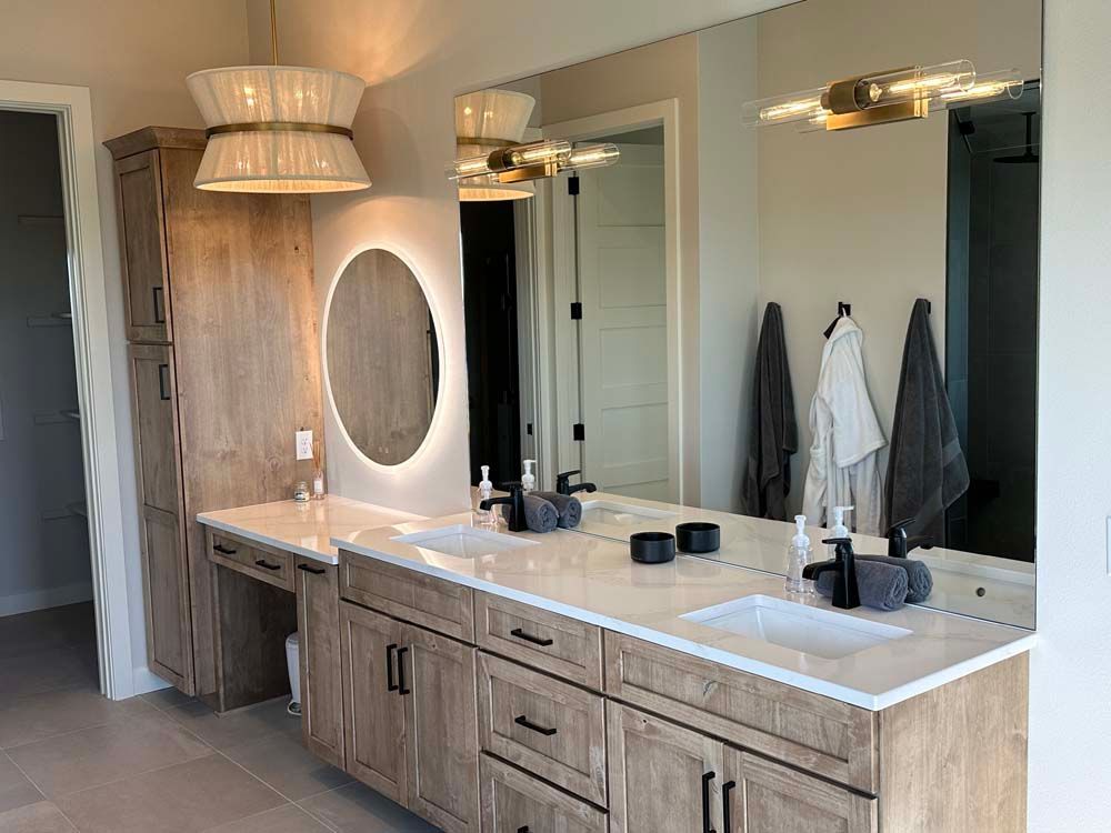 A bathroom with two sinks and a large mirror.