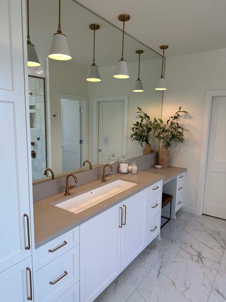 A bathroom with two sinks and a large mirror.