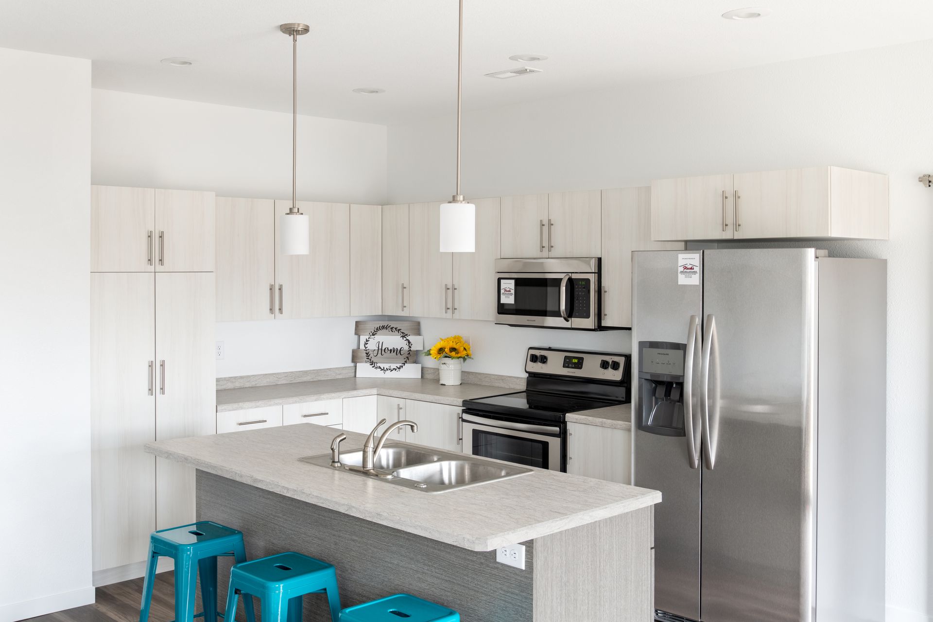 A kitchen with stainless steel appliances and white cabinets