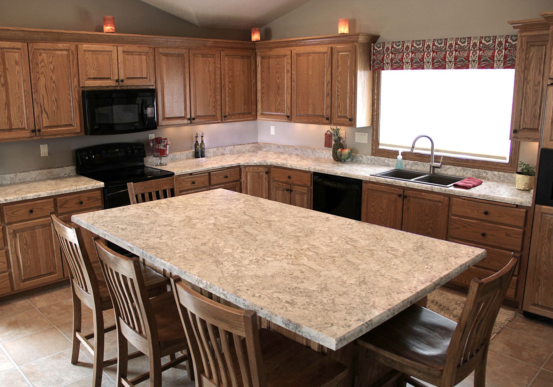 A kitchen with a large table and chairs in it