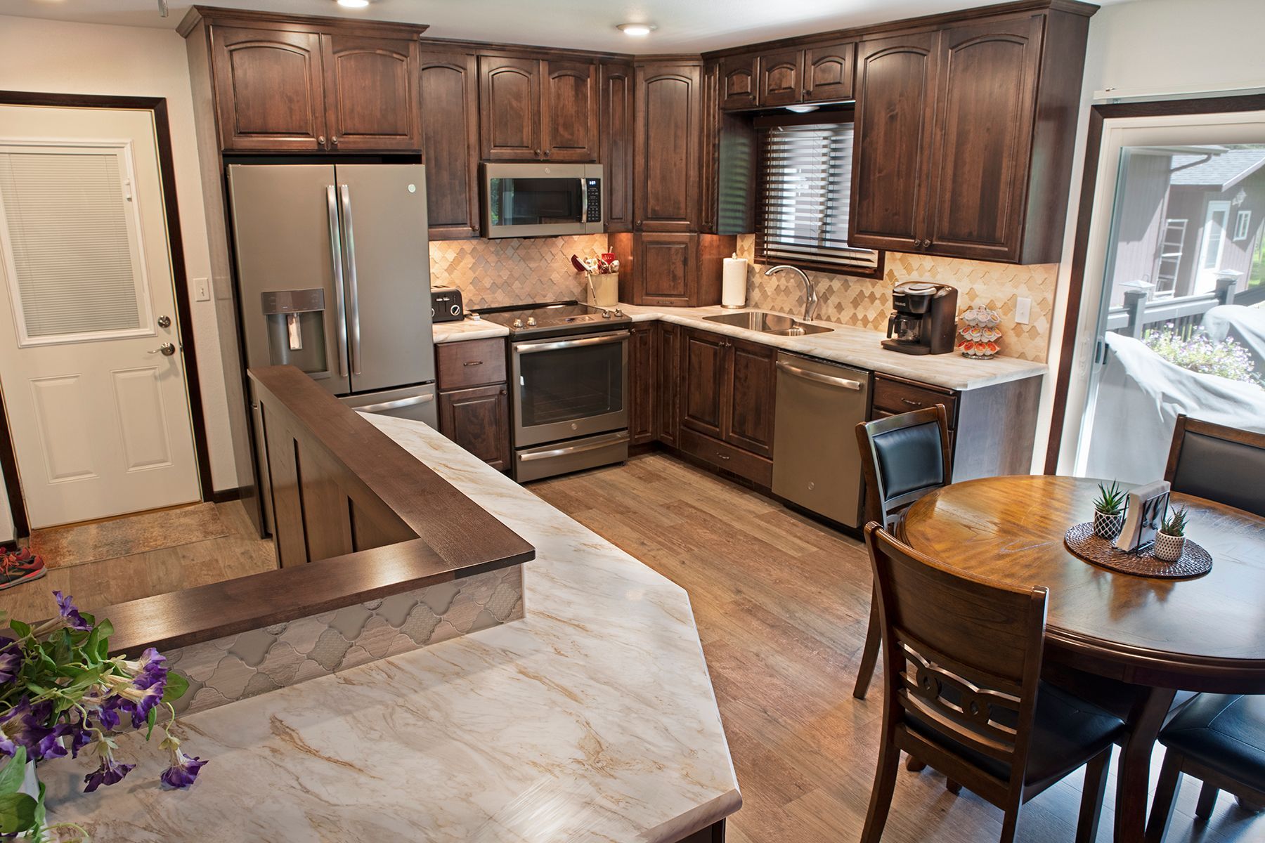 A kitchen with stainless steel appliances and wooden cabinets