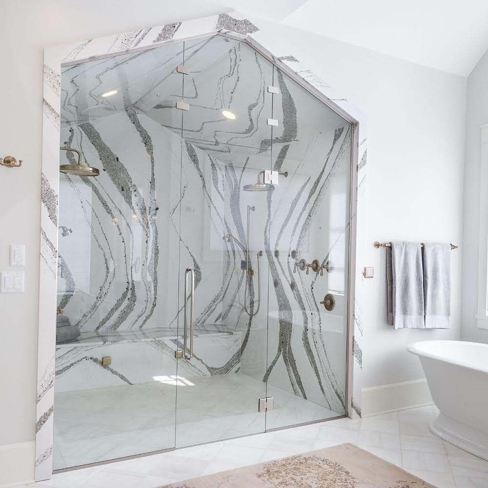 A bathroom with a bathtub and a shower with a glass door