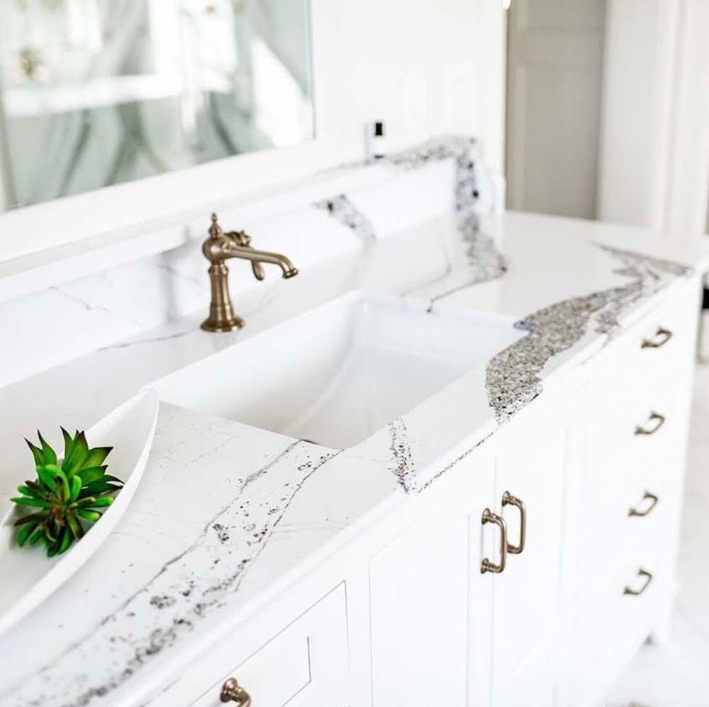 A bathroom with a double sink and a mirror.