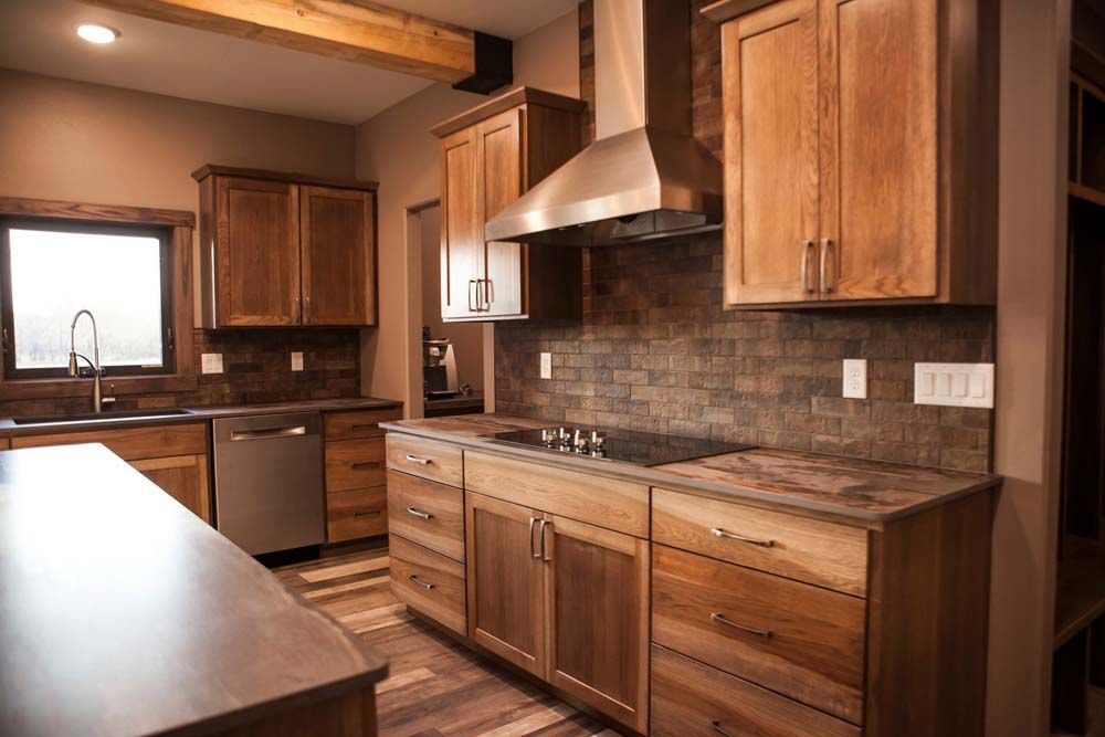 A kitchen with wooden cabinets and stainless steel appliances.