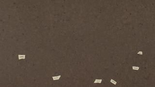 A close up of a piece of brown paper with white letters on it.