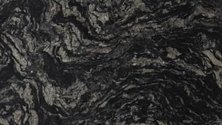 A close up of a black granite counter top with a marble texture.