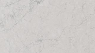 A close up of a white marble counter top.