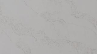 A close up of a white marble counter top.