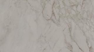 A close up of a white marble counter top.