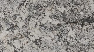 A close up of a black and white granite counter top.