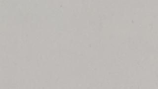 A close up of a white surface with a grainy texture.