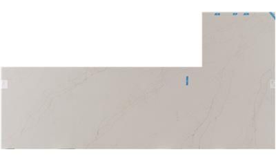 A white tile with a blue sticker on it is sitting on a white surface.