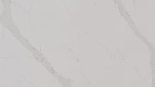 A close up of a white marble tile with a marble texture.