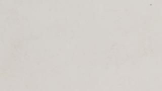 A close up of a white surface with a grainy texture.