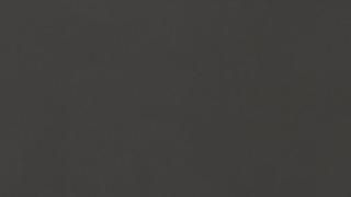 A close up of a black background with a plain texture.