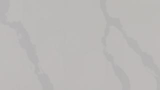 A close up of a white tile with a marble texture.