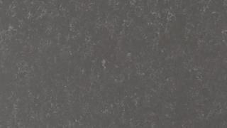 A close up of a gray surface with white spots on it.