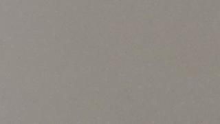 A close up of a gray paper texture.