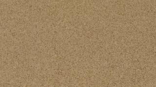 A close up of a piece of brown paper with a grainy texture.