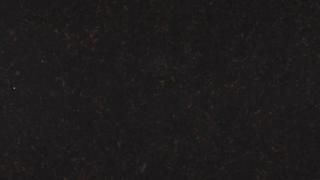 A close up of a black surface with a grainy texture.