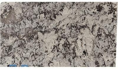 A close up of a white granite slab on a white background.