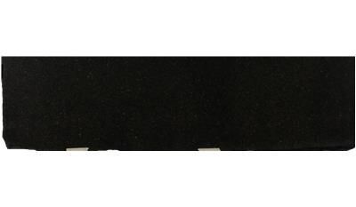 A black piece of paper is sitting on a white surface.