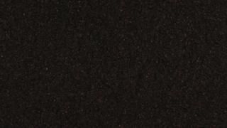 A close up of a black surface with a grainy texture.