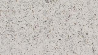 A close up of a white granite counter top.