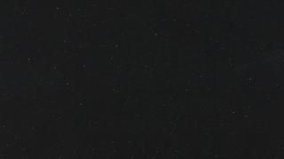 A close up of a black surface with a lot of small dots on it.