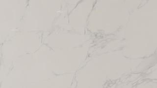 A close up of a white marble counter top.