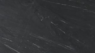 A close up of a black marble counter top.