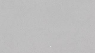 A close up of a gray background with a white circle in the middle.