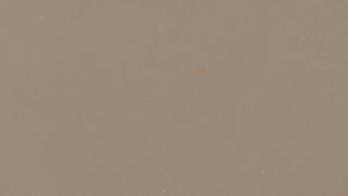 A close up of a piece of paper with a brown stain on it.