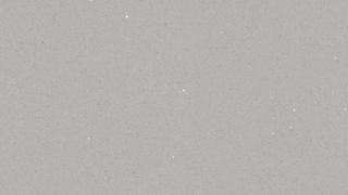 A close up of a piece of gray paper with a grainy texture.
