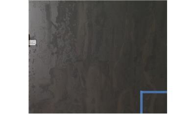 A close up of a black wall with a blue line on it.