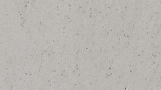 A close up of a white surface with small dots on it.