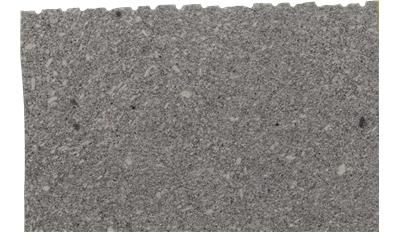 A close up of a piece of gray granite on a white background.