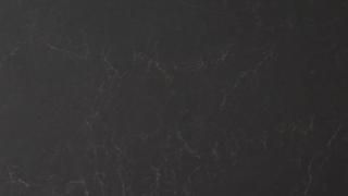 A close up of a black surface with a grainy texture.