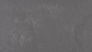 A close up of a gray surface with a grainy texture.