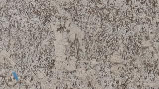 A close up of a white granite counter top.