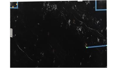 A close up of a black surface with blue lines on it.