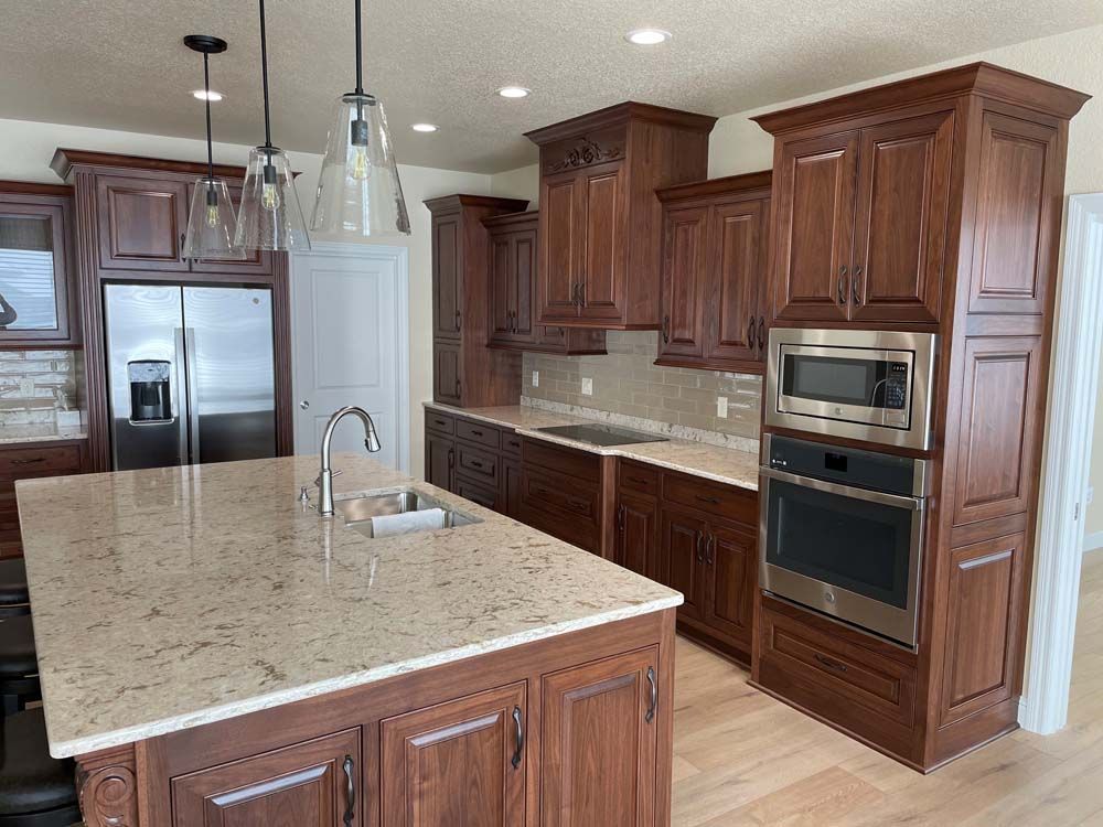 A kitchen with stainless steel appliances and wooden cabinets
