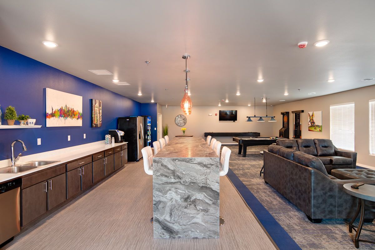 A large room with a lot of furniture and a pool table.