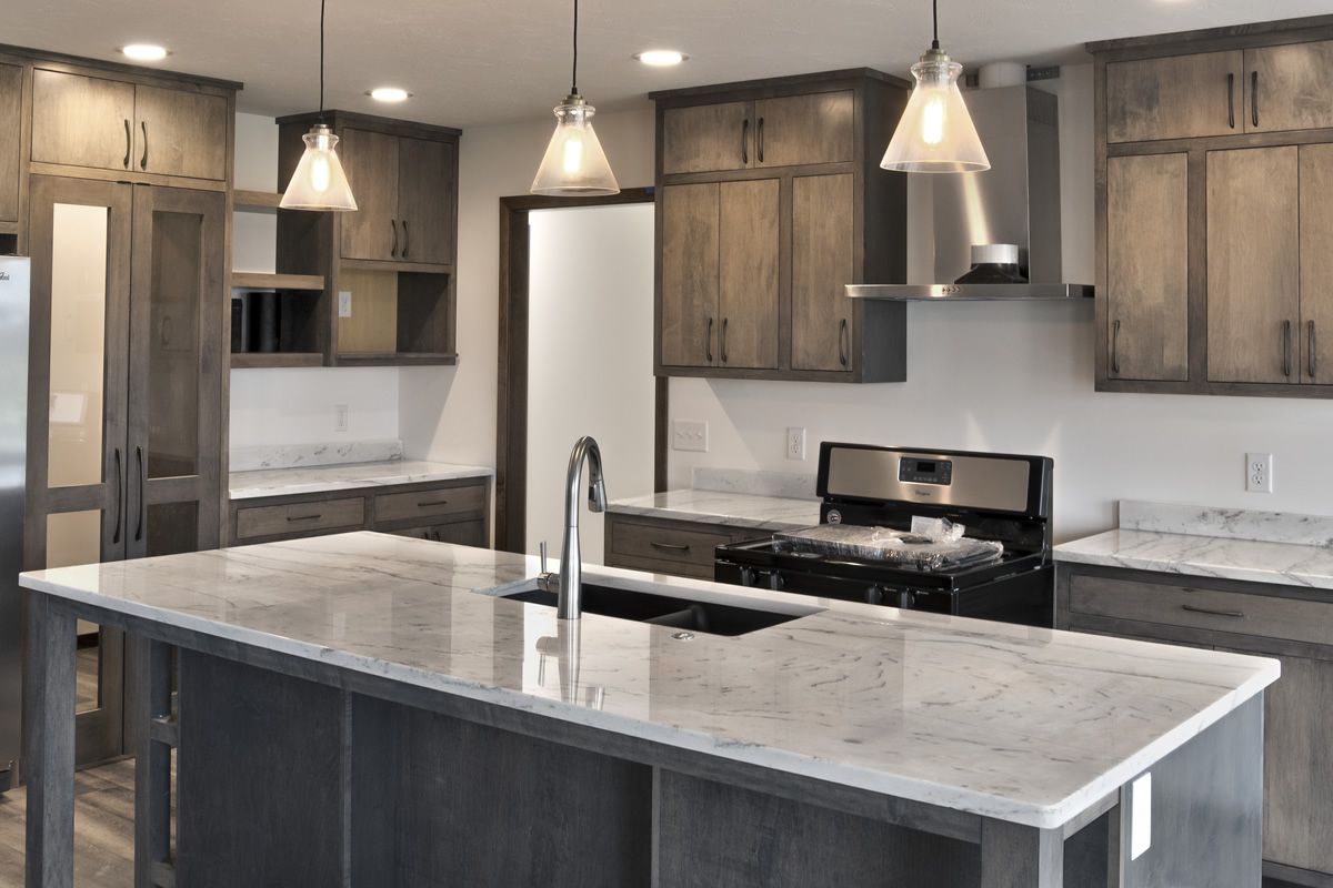 A kitchen with stainless steel appliances and granite counter tops.