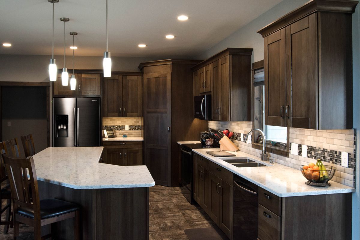 A kitchen with stainless steel appliances and wooden cabinets