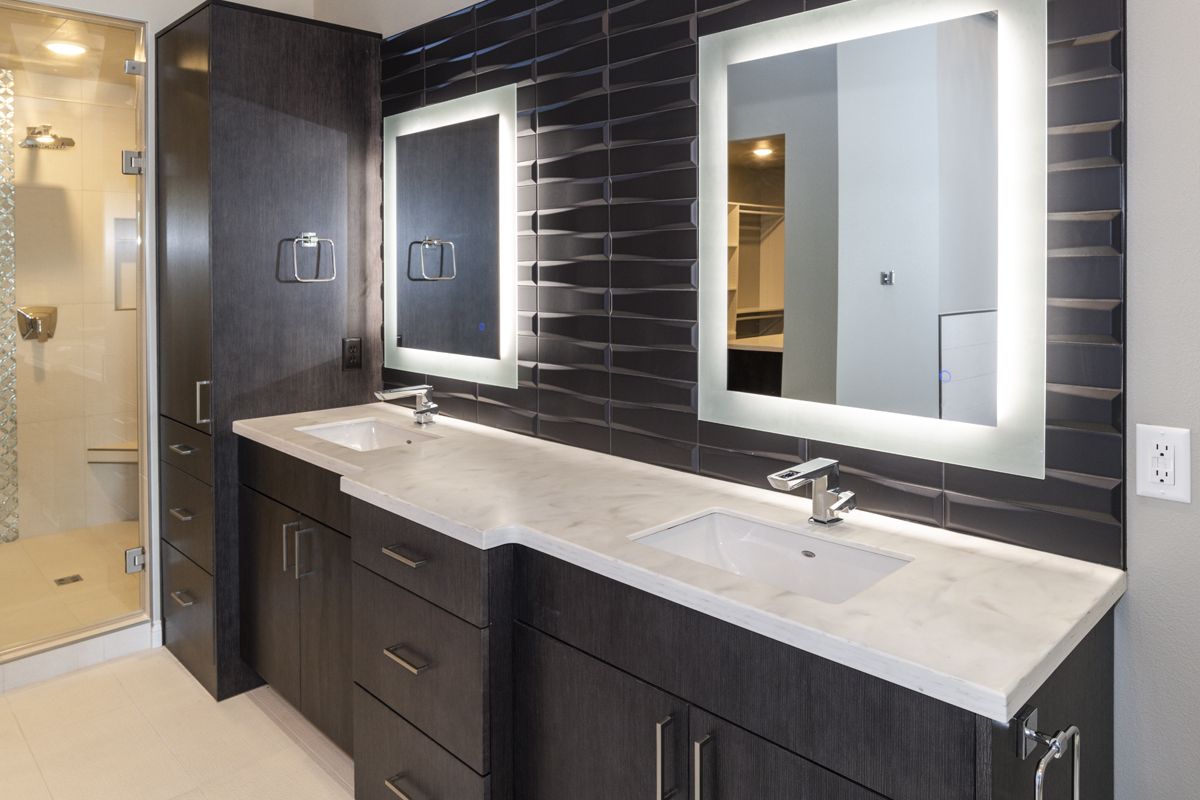 A bathroom with two sinks and two mirrors.