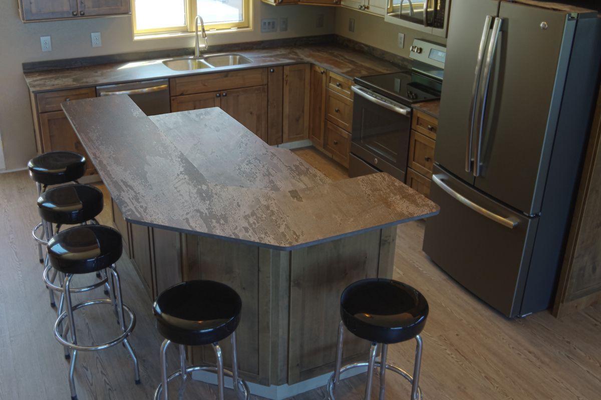 A kitchen with a large island and stools