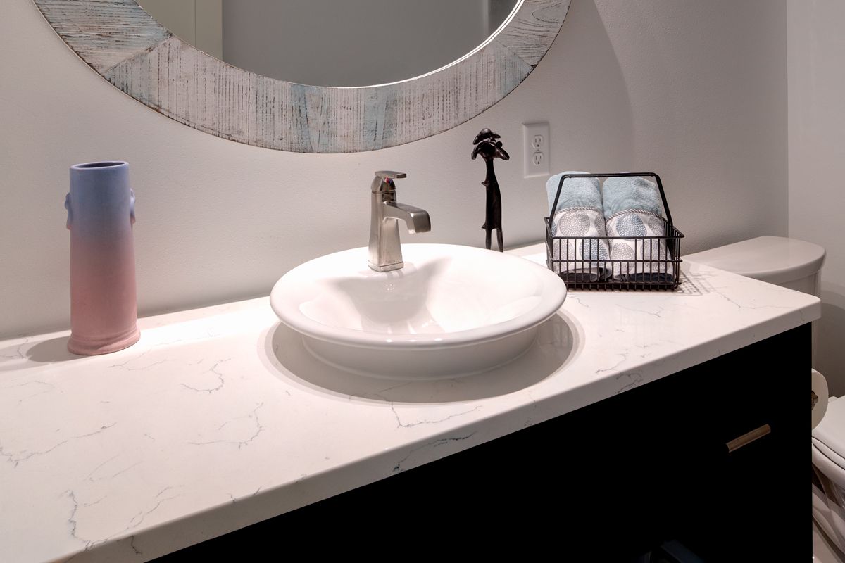 A bathroom with a sink , toilet and mirror.