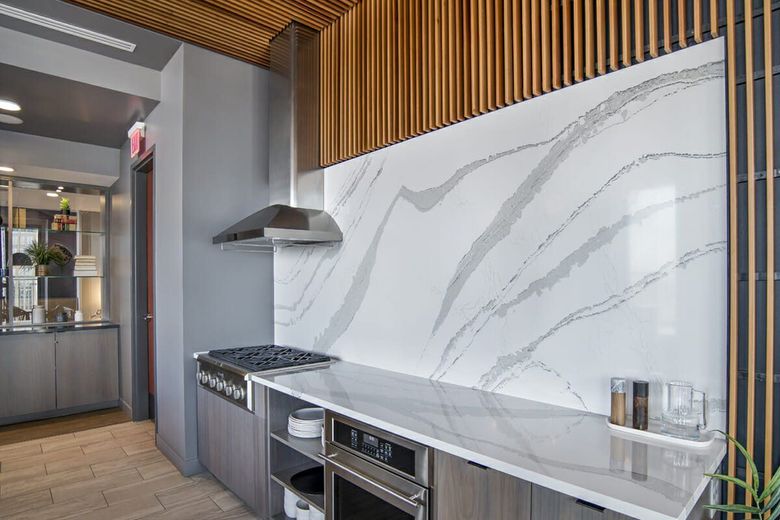 A kitchen with a stove , oven , and hood.