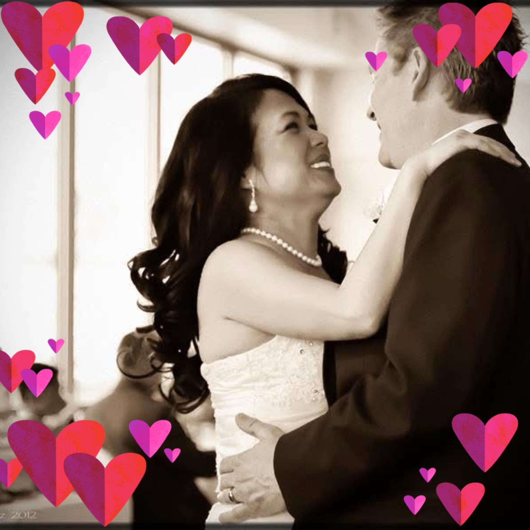 A woman wearing sunglasses and a pearl necklace is standing in front of a shower curtain.